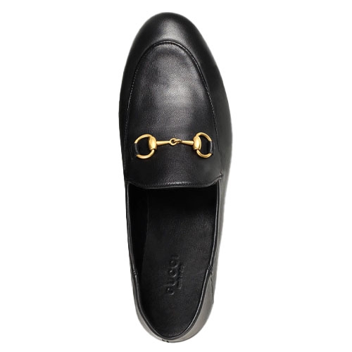 A black leather loafer with a gold horsebit detail on the upper.