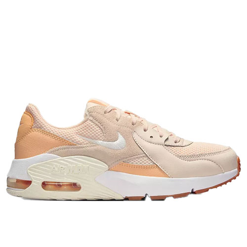 A light peach and beige sneaker featuring a mesh and suede upper, white midsole with visible air cushioning, and an orange-tinted outsole.