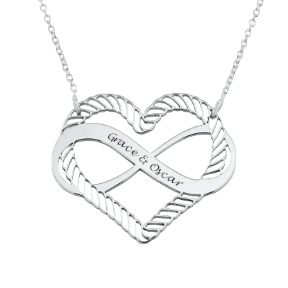 A silver heart-shaped pendant with an infinity symbol design, featuring the engraved names \“Grace & Oscar,\“ attached to a delicate chain.