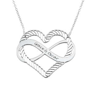 A silver heart-shaped pendant with an infinity symbol design, featuring the engraved names \“Grace & Oscar,\“ attached to a delicate chain.