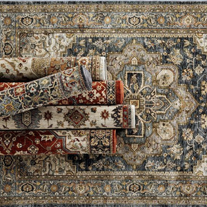A collection of rolled decorative Persian-style rugs with intricate patterns in warm and neutral colors, displayed on a larger, similarly patterned rug background.