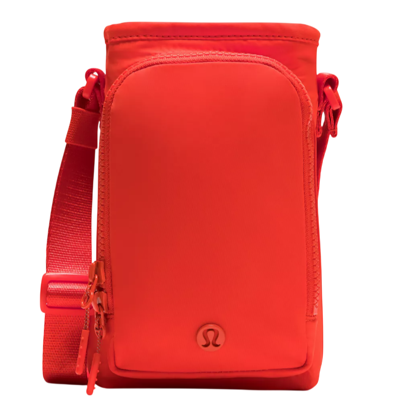 A compact, vibrant red crossbody bag with a top zipper, front pocket, and adjustable shoulder strap, featuring the Lululemon logo.