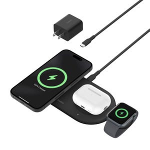 A wireless charging pad with an Apple smartphone, AirPods, and smartwatch charging simultaneously, accompanied by a wall charger and a USB-C cable.