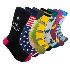 A set of colorful socks featuring various playful designs: \“MR COOL\“ text on black, stars on blue, dinosaurs, tacos, and a cartoon shark, each with unique color schemes and patterns.