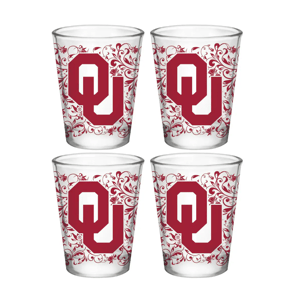 Four shot glasses featuring a decorative design with the \“OU\“ logo in red, indicative of the University of Oklahoma.