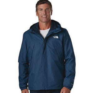 The North Face Triclimate Jacket is a versatile, blue waterproof jacket with a hood, featuring layered construction suitable for varied weather conditions.