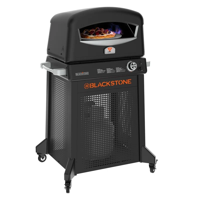 Blackstone outdoor pizza oven with a black finish, featuring a visible flame and a pizza inside. It has a front control knob and a cabinet with wheels for mobility.