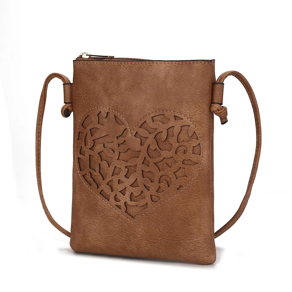 Brown crossbody bag with a zip closure and an intricately cut-out heart design on the front. Features a thin, adjustable strap.