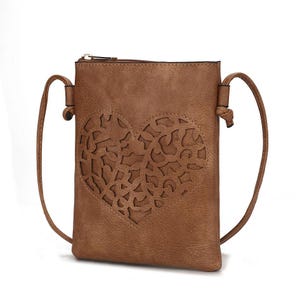 Brown crossbody bag with a zip closure and an intricately cut-out heart design on the front. Features a thin, adjustable strap.