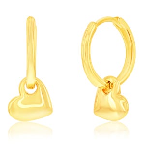 Gold hoop earrings with heart-shaped charms.