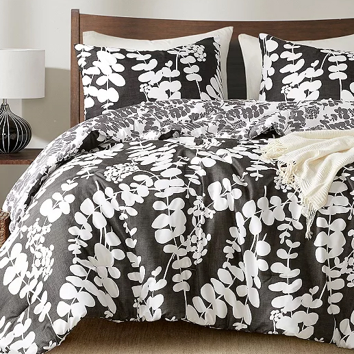 3pc Reversible Queen Comforter Set with a bold gray and white leaf pattern; includes a comforter and two pillow shams. The design is modern with a natural theme, suitable for a contemporary bedroom look.