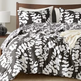 3pc Reversible Queen Comforter Set with a bold gray and white leaf pattern; includes a comforter and two pillow shams. The design is modern with a natural theme, suitable for a contemporary bedroom look.