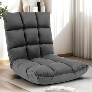Gray floor chair with a padded, tufted design, positioned on a light-colored rug in a room with natural light and minimal decor.