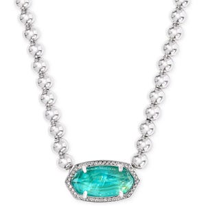 A silver chain necklace with round, reflective beads features a large, hexagonal blue-green gemstone encircled by small clear stones.