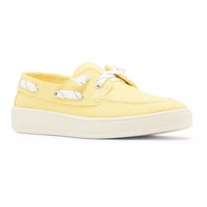 Yellow canvas boat shoe with white laces and a white sole.