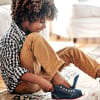 young boy putting on shoes