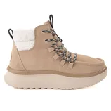 A beige suede boot with black and white laces, a plush white fleece lining, and a thick, textured sole.