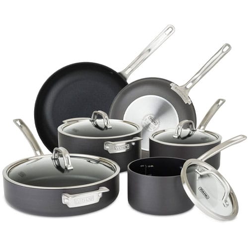 Cookware set including two frying pans and four lidded pots, all in non-stick, dark material with stainless steel handles.