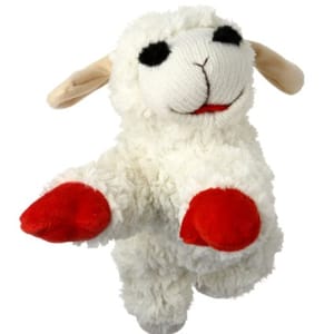 A plush dog toy resembling a white lamb with a smiling face, featuring beige ears, and red hooves.