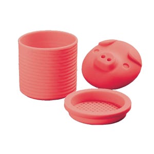 A set of silicone garlic peeling tools with a cylindrical tube and a flat base with small holes, accompanied by a pig-shaped lid.