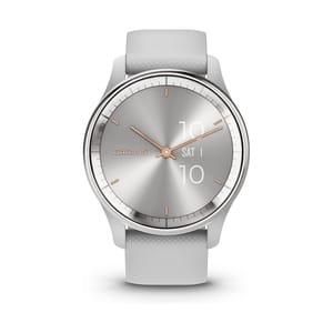Garmin smartwatch with a sleek silver face, rose gold accents, and a gray textured strap. The watch displays the brand name \“GARMIN,\“ analog time, and digital date and time on the face.