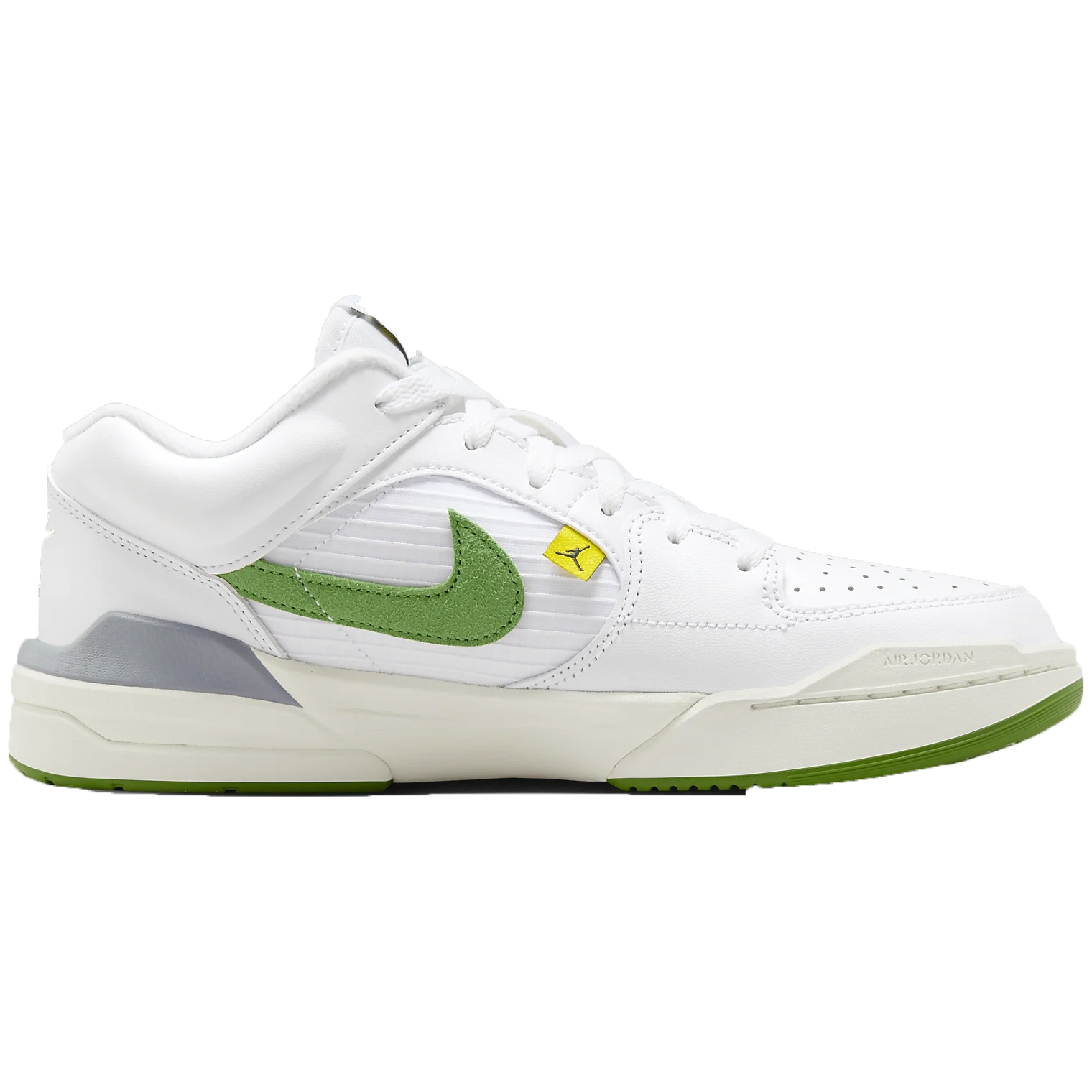 White sneakers with green and yellow accents, featuring a prominent Nike swoosh logo and a yellow Jordan emblem on the Velcro strap.