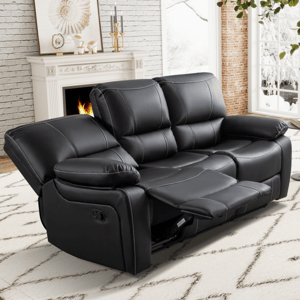 Black leather reclining sofa in a cozy living room with a white fireplace, wall art, and a snowy outdoor view through large windows.