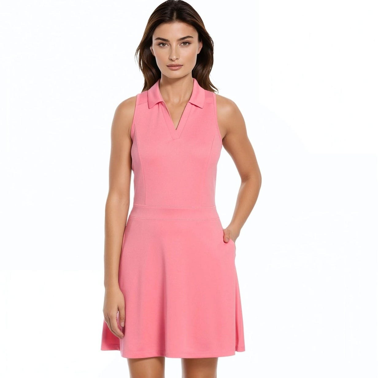 A woman wears a sleeveless pink dress with a V-neck and a fitted waist, made from a lightweight fabric.