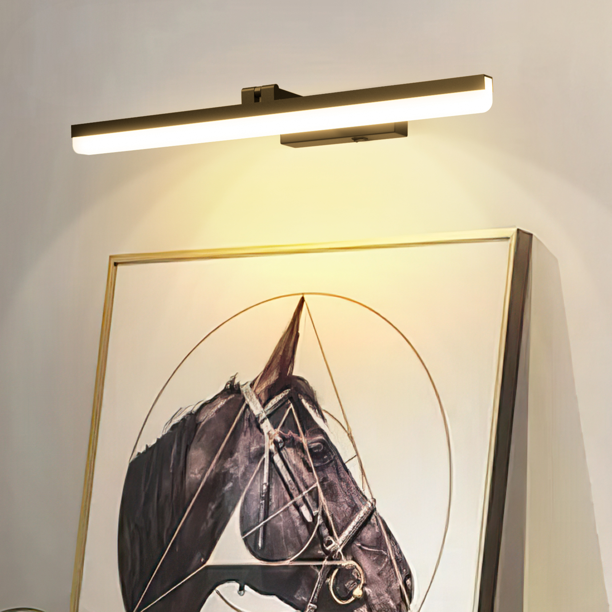 A sleek, modern wireless wall light with an elongated rectangular shape is mounted above a picture, casting a warm, diffused light downward.