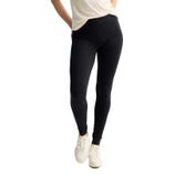 Black high-waisted leggings paired with white sneakers and a light-colored top.