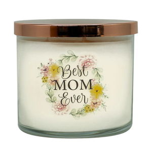 A white, round Colonial Candle with a copper lid features the words \“Best Mom Ever\“ in black script surrounded by a floral wreath in pastel colors.