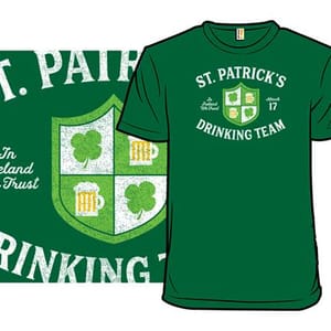 Green T-shirt featuring a design with the text \“St. Patrick's Drinking Team,\“ a shield with shamrocks and beer mugs, and the phrase \“In Ireland We Trust.\“