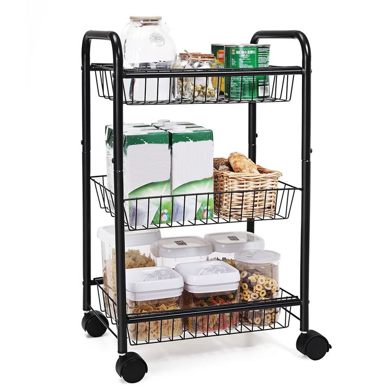 A black 3-tier rolling storage cart holds various items: the top tier has glass jars and canned goods, the middle tier has boxes and a basket of bread, and the bottom tier contains sealed plastic containers with pasta and cereal.