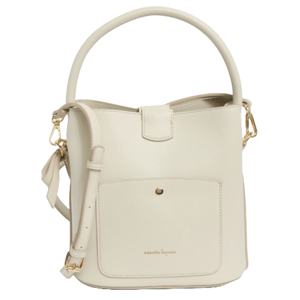 Nanette Lepore bucket bag in off-white features a front pocket, top handle, and detachable shoulder strap with gold-tone hardware accents.
