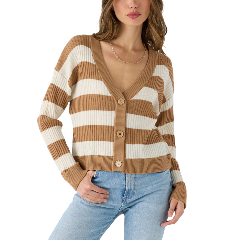 A woman is wearing a ribbed, button-up cardigan with tan and white horizontal stripes, paired with light blue jeans.