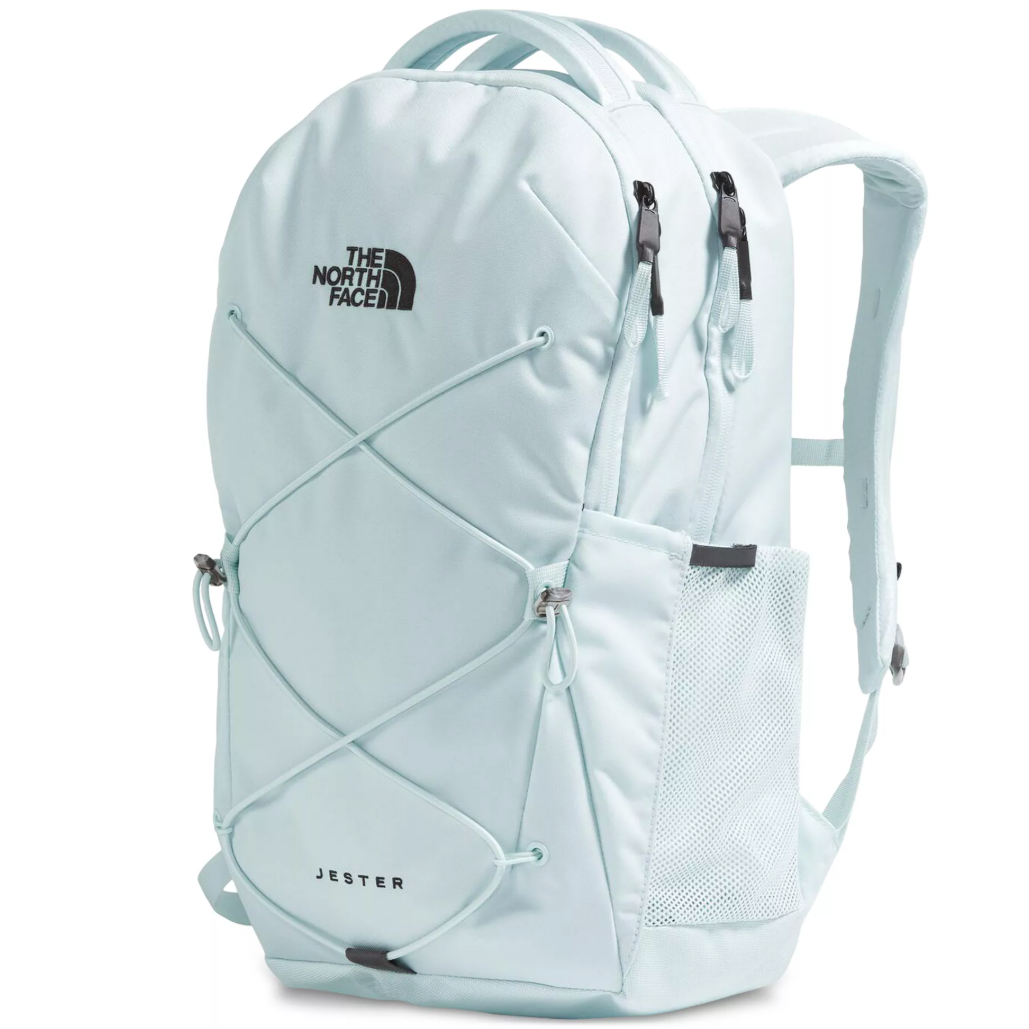 A light blue North Face Jester backpack with a front bungee system, mesh side pocket, and dual zipper compartments.