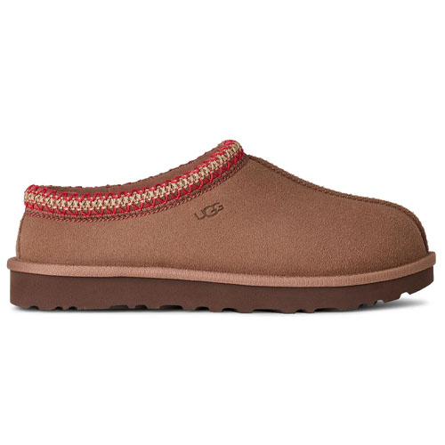 A brown suede UGG slipper with a red and tan woven trim around the opening, featuring a flat sole and slip-on design.
