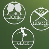 Three personalized sports-themed ornaments feature a pickleball set for John, a baseball design for Elizabeth, and a gymnast pose for Gracie, all marked with \“2025.\“