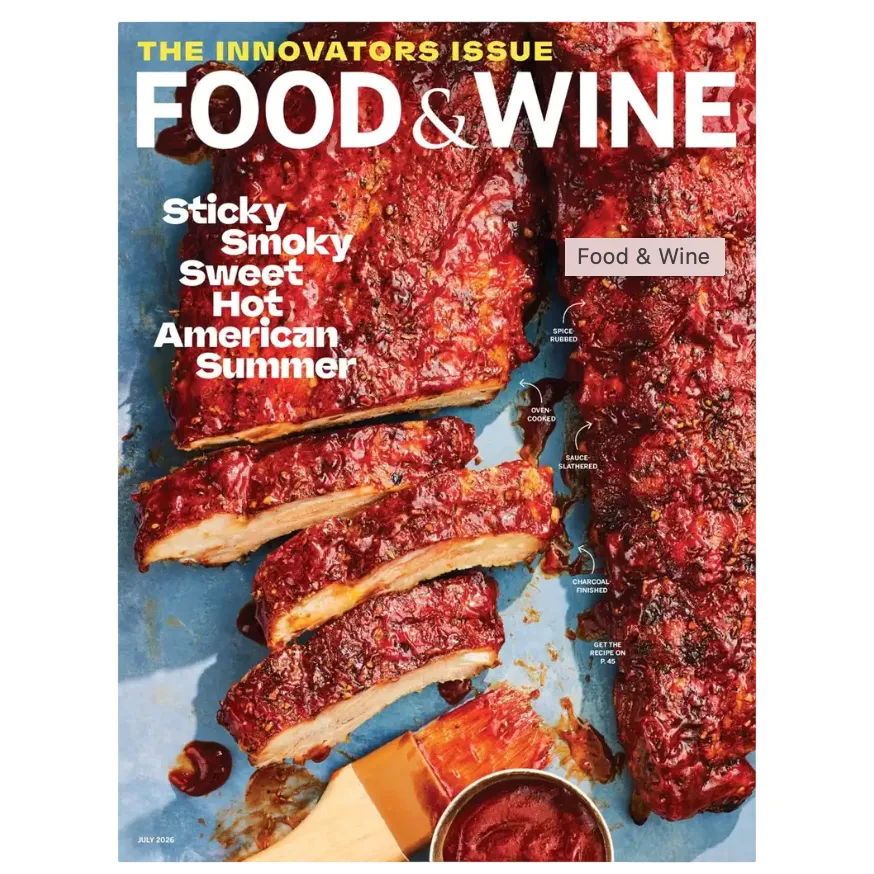 Food & Wine magazine cover featuring saucy, sliced ribs with text describing the preparation as \“sticky, smoky, sweet, hot\“ and detailing the process: spice-rubbed, oven-cooked, sauce-slathered, and charcoal-finished.