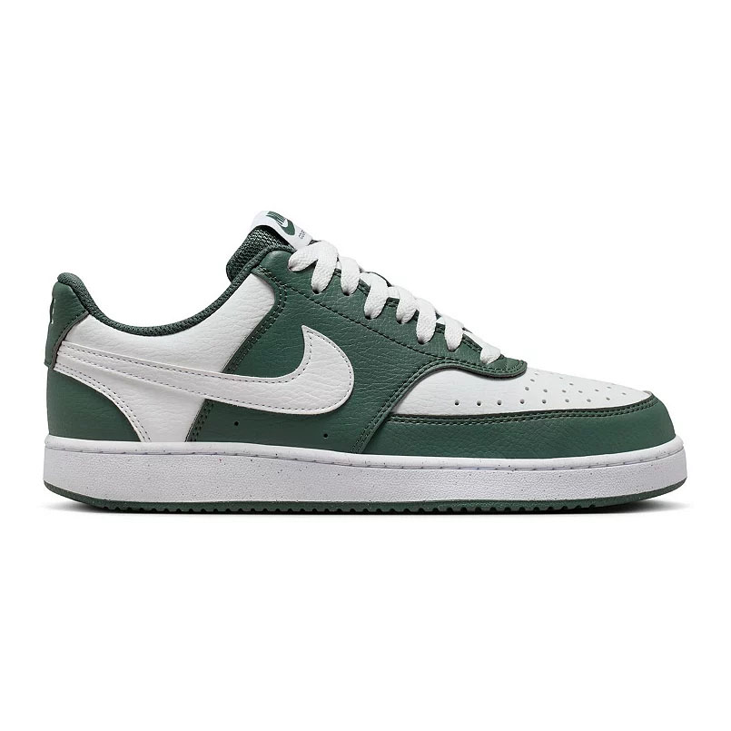 A Nike Court Vision Low shoe in green and white, featuring a leather upper with perforations, a signature Nike swoosh, and a rubber sole.