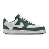 A Nike Court Vision Low shoe in green and white, featuring a leather upper with perforations, a signature Nike swoosh, and a rubber sole.