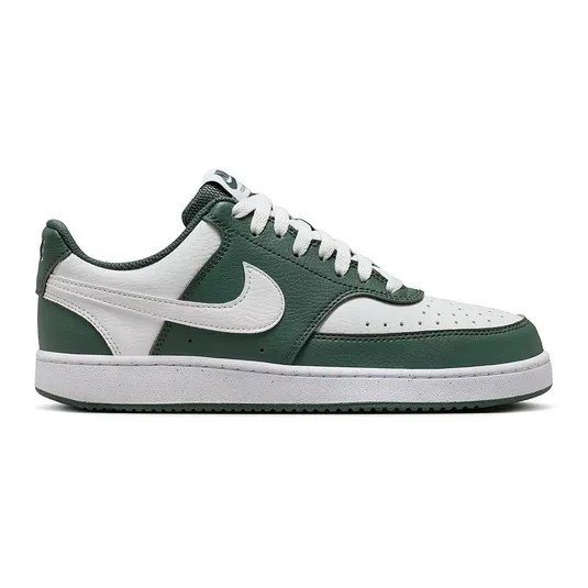 A Nike Court Vision Low shoe in green and white, featuring a leather upper with perforations, a signature Nike swoosh, and a rubber sole.