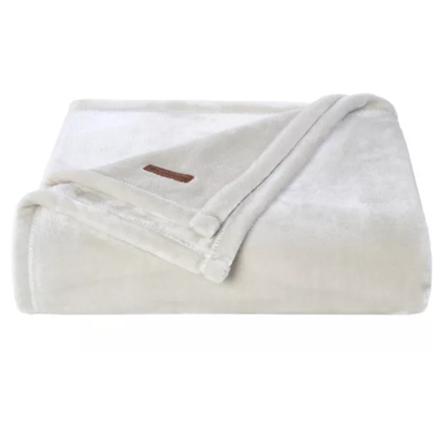 A folded, cream-colored Columbia Plush Throw featuring a soft, velvety texture with a small brown logo patch on the corner.