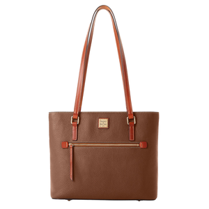 A brown leather Dooney & Bourke tote bag with a pebbled texture, featuring a front zipper pocket, two long shoulder straps, and a branded patch.