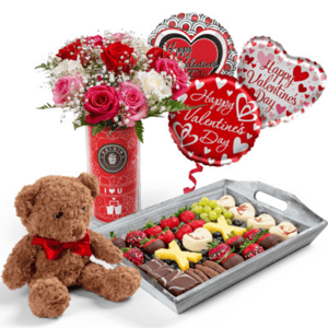 The Forever & Always Gift Set includes a bouquet of mixed roses, a teddy bear with a red bow, heart-themed Valentine's Day balloons, and a tray of chocolate-covered fruits and treats.