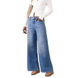 Blue wide-leg jeans paired with a white ribbed long-sleeve top. Designed for a relaxed fit, they're styled with casual brown moccasins.