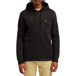 A black hooded sweatshirt with a pocket and subtle logo detail on the chest, paired with beige pants featuring graphics along the leg.