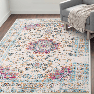 A 5' x 7' area rug with a stain-resistant finish, featuring an intricate floral and geometric pattern with vibrant colors including pink, blue, and orange on a light background.