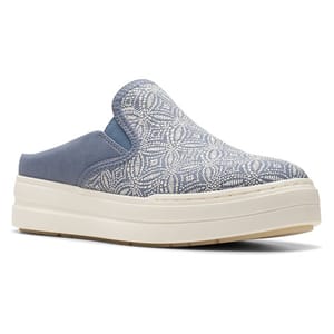 A slip-on mule with a blue and white patterned fabric upper, thick white sole, and blue elastic detail at the instep.