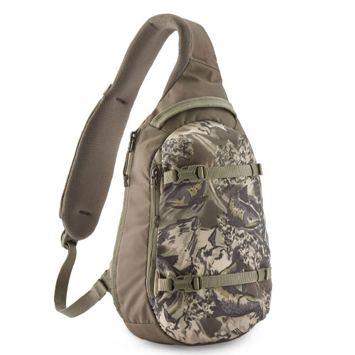 A camouflage-patterned sling backpack with padded shoulder strap, multiple compartments, and adjustable straps for securing gear.
